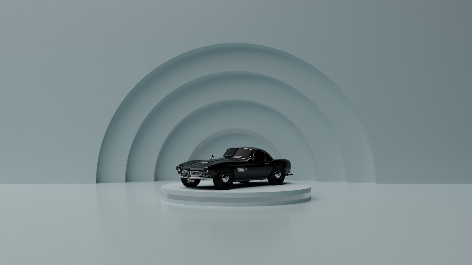 a black car on a white platform